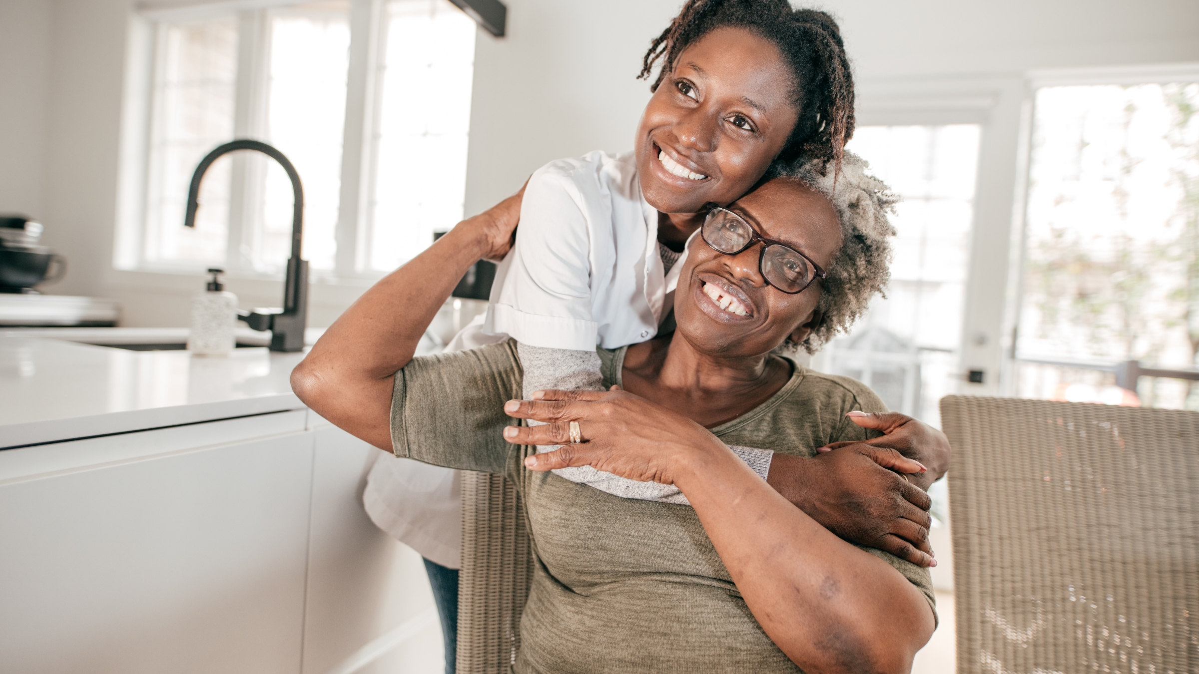 Caregiver and senior laughing together during a visit